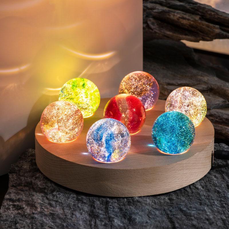 Cosmic lamp: Luminous Galaxy Orb LED spheres displayed on a shelf, enhancing home decor with celestial light.