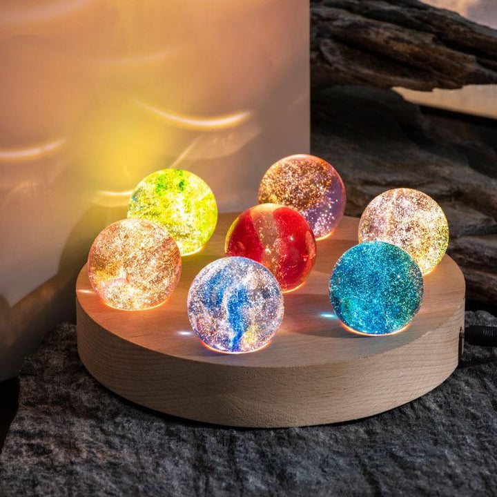 Cosmic lamp: Luminous Galaxy Orb LED spheres displayed on a shelf, enhancing home decor with celestial light.