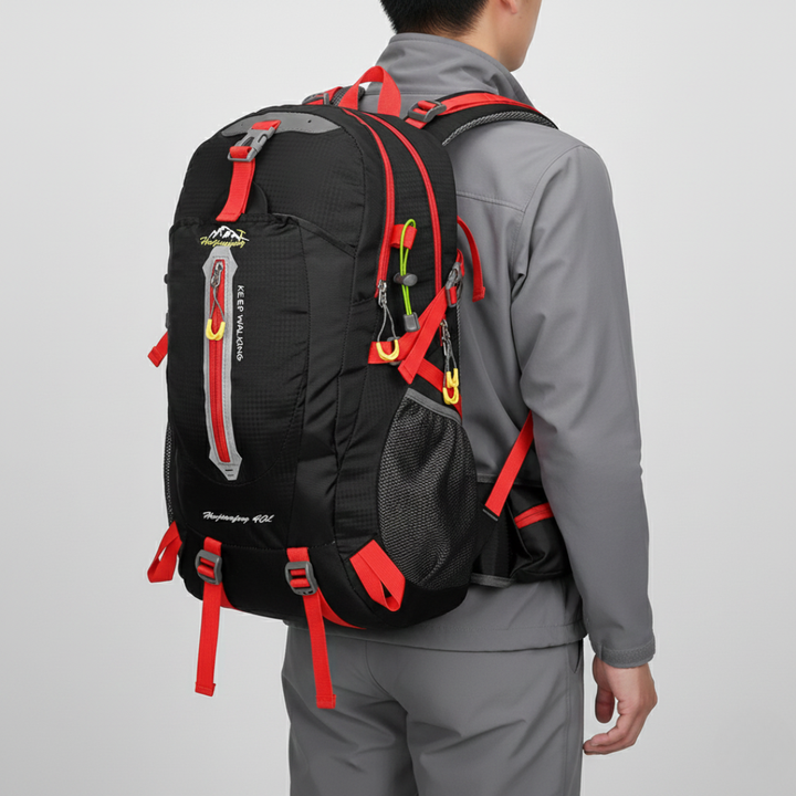 Person wearing a 40L water resistant unisex outdoor backpack on a scenic hiking trail.