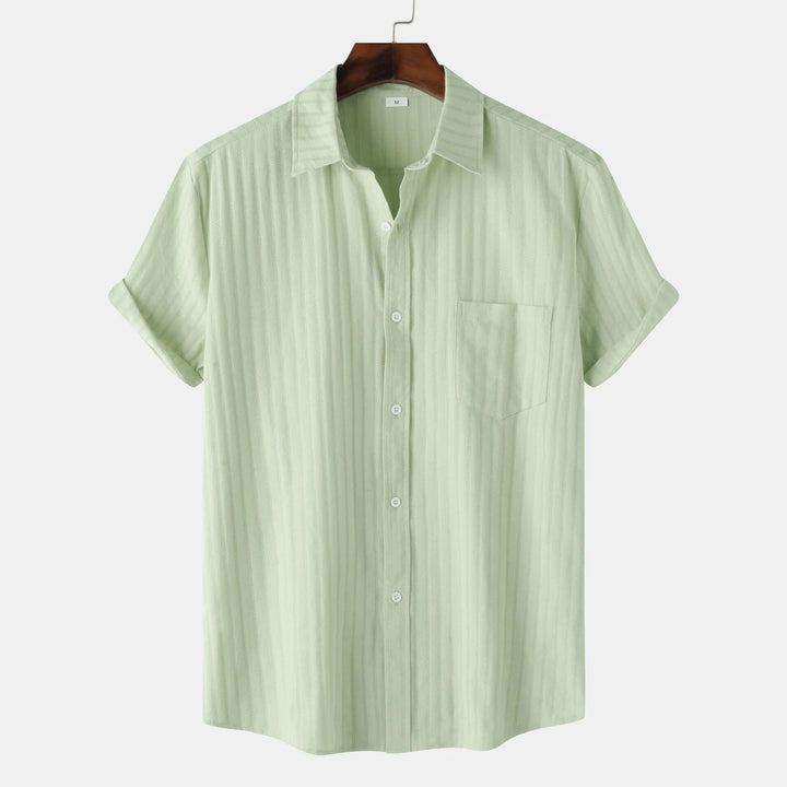 Men's smart casual short sleeve button-down shirt featuring a single chest pocket and classic collar. Versatile.