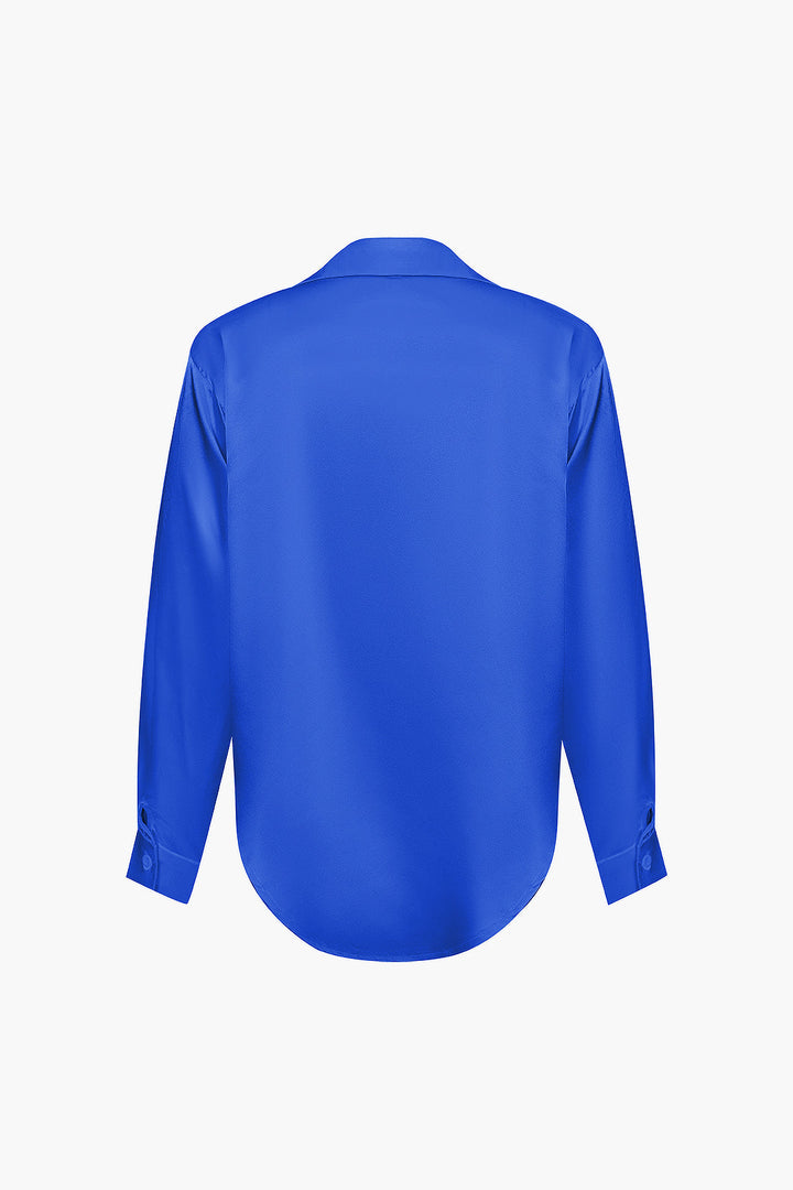 Crisp women's long-sleeve button-down shirt, ideal for professional style.