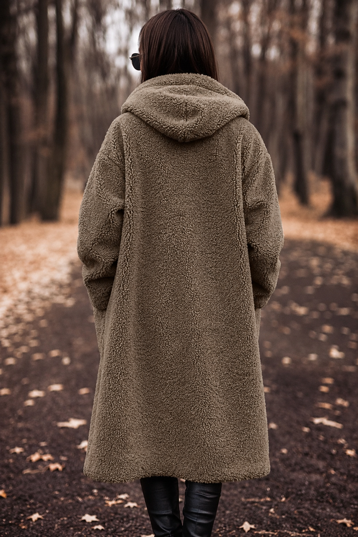 Women's cozy hooded long coat for winter, offering both warmth and chic versatile style.