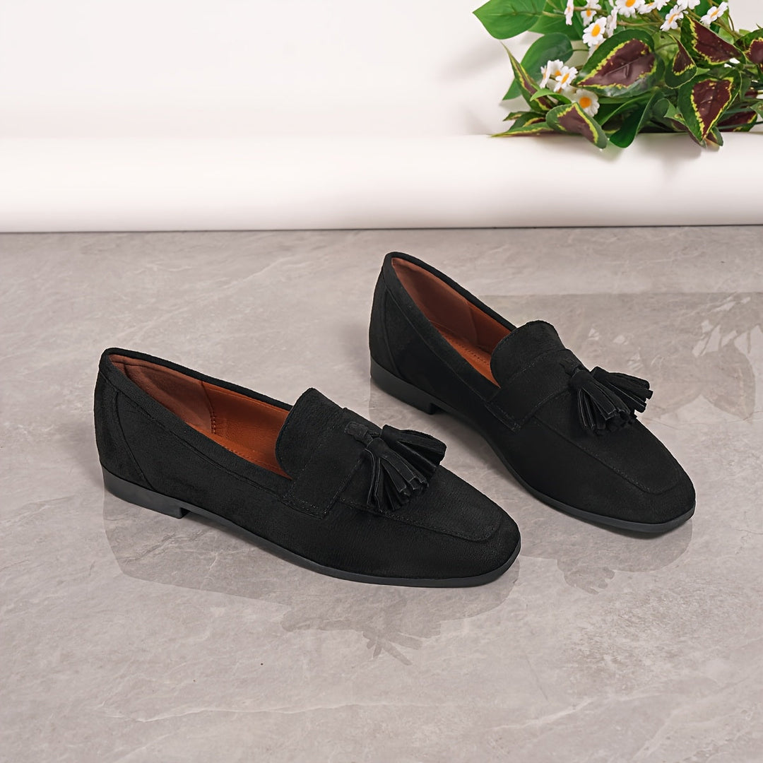 Versatile navy blue women's tassel loafers, ideal slip-on footwear for office or relaxed wear.