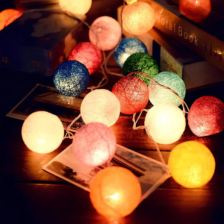 Decorative warm LED garland with cotton balls, creating a soft and dreamy lighting effect.