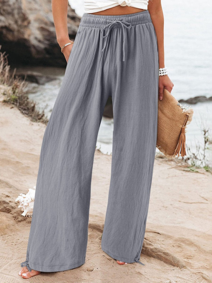 Relaxed fit wide-leg trousers with a high waist and adjustable drawstring, ideal for everyday wear.
