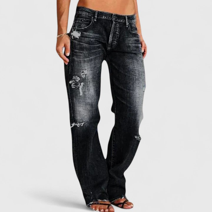 Mid-rise distressed wide leg denim jeans for women, offering a relaxed fit and a chic street style look.