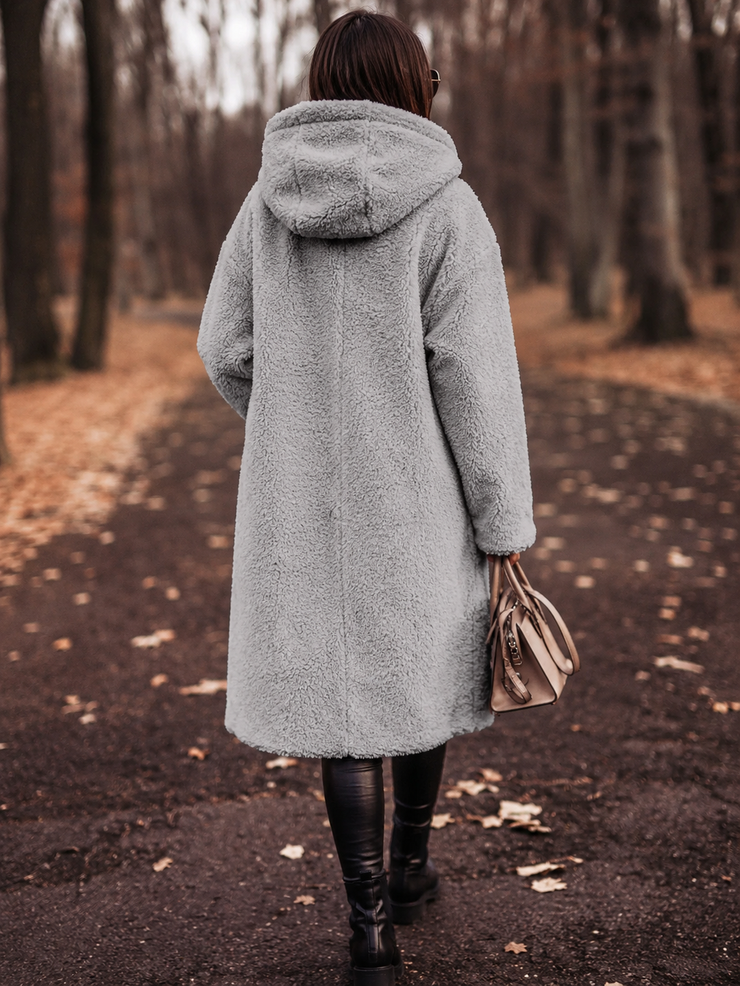 Stylish women's winter coat with a hood, knee-length for warmth and a chic, cozy look.