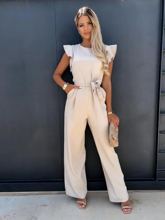 Women's ruffle sleeve, wide leg belted jumpsuit. Elegant one-piece summer outfit for casual or dressy occasions.