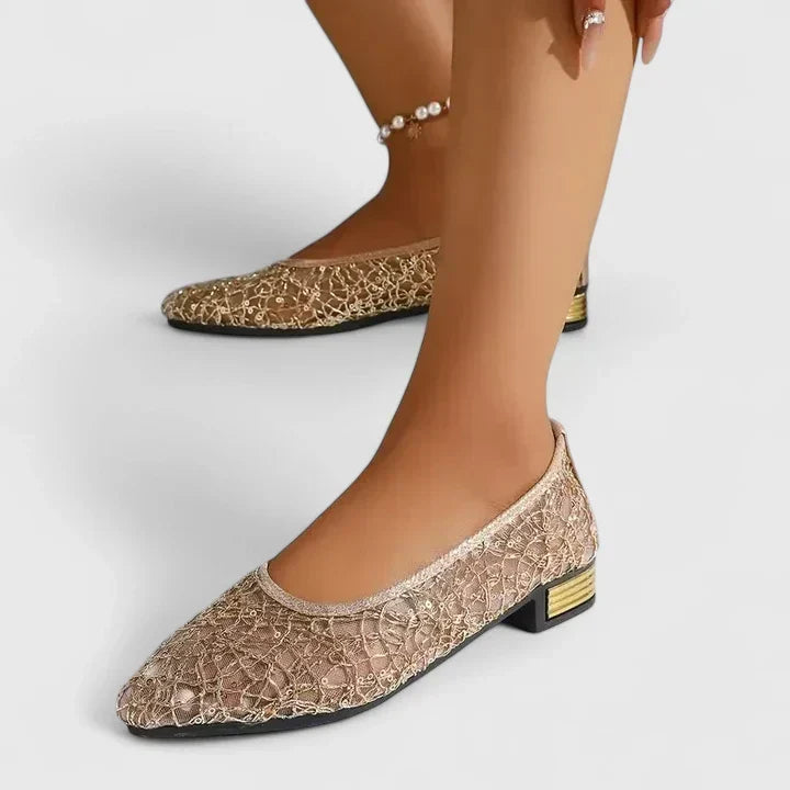 Sophisticated black women's dressy flats with a chic pointed toe and elegant gold heel for parties or weddings.