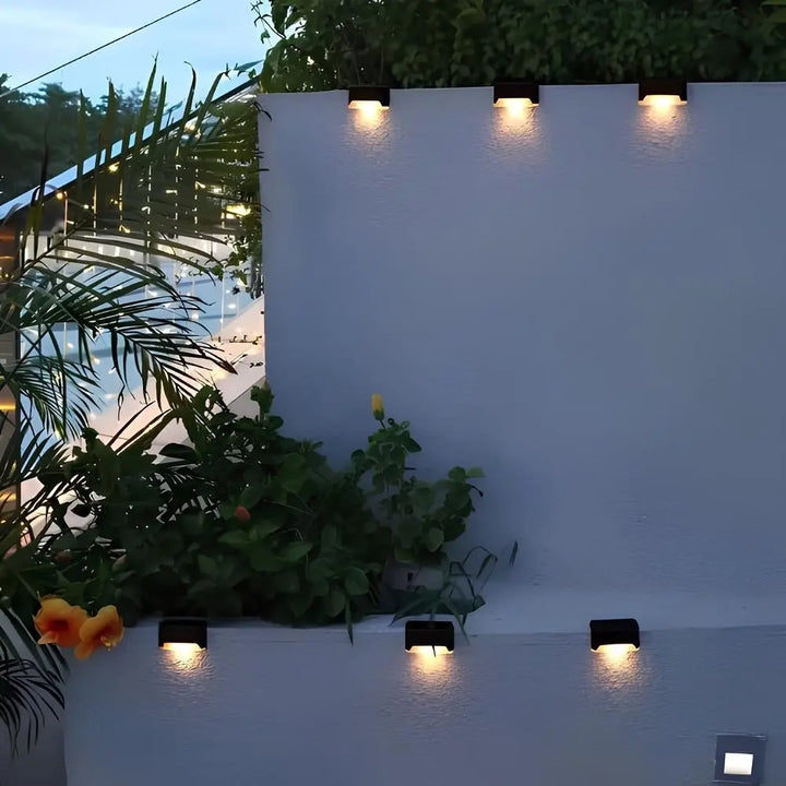 A row of Nvroome solar step lights providing elegant, no-wiring landscape lighting at night.