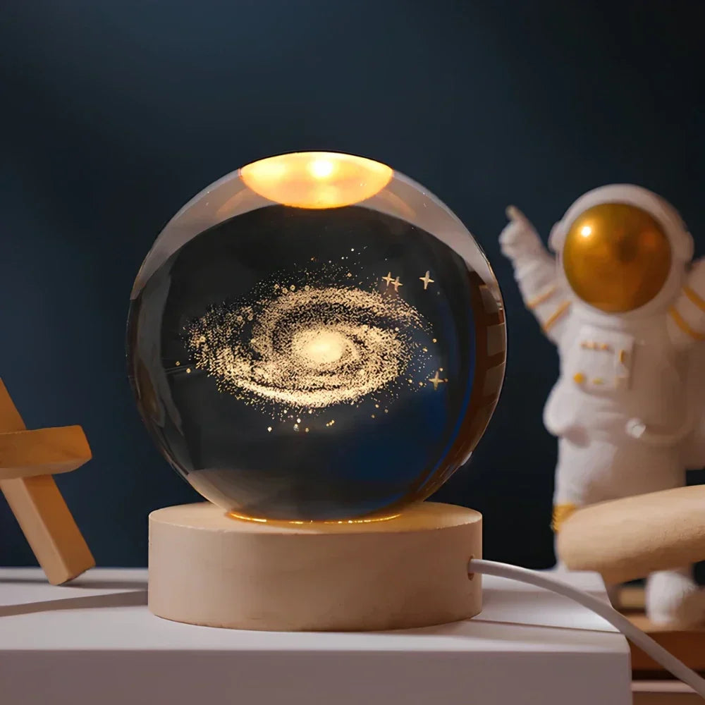 Luminous 3D engraved galaxy crystal ball lamp, showcasing stunning cosmic patterns on a stylish wooden base.
