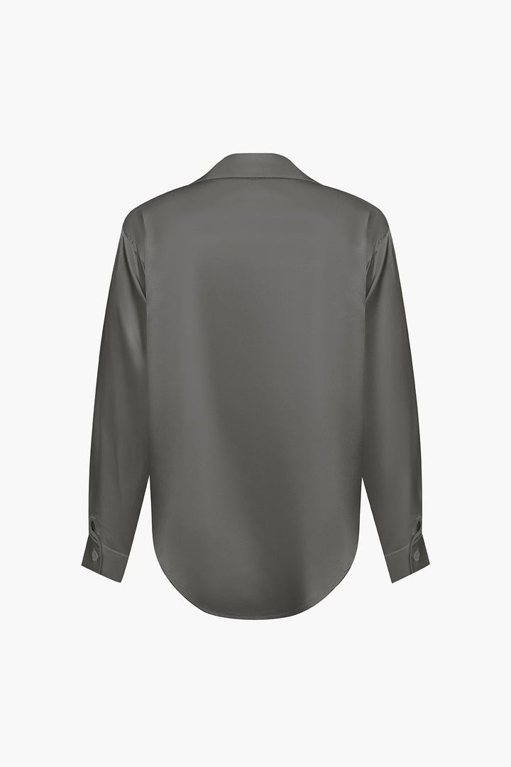 Sophisticated women's long-sleeve button-down top, a versatile piece for office.