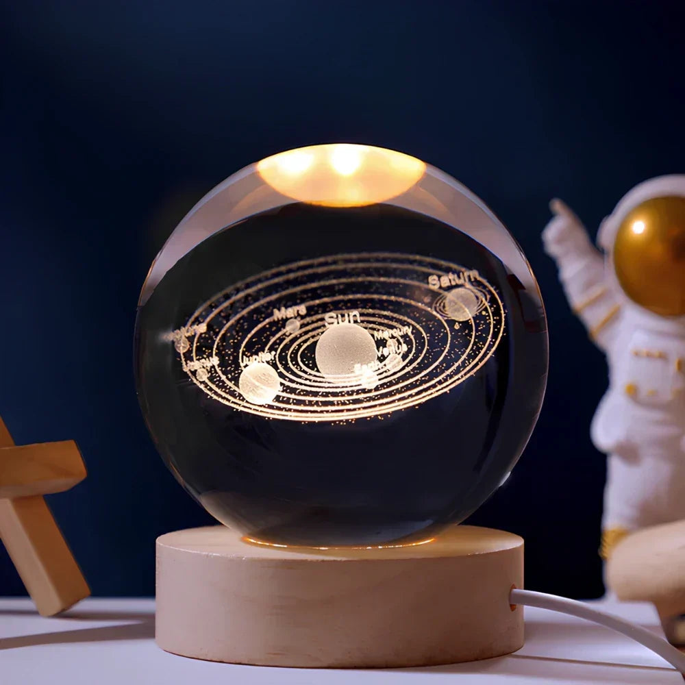 Unisex 3D galaxy LED crystal ball desk lamp, glowing vividly on a wooden base. Ideal unique gift or night light.