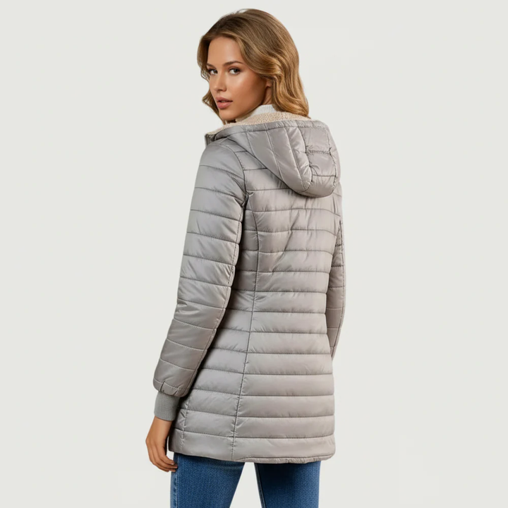Hooded longline women's puffer jacket with quilted pattern & soft lining for ultimate winter warmth.