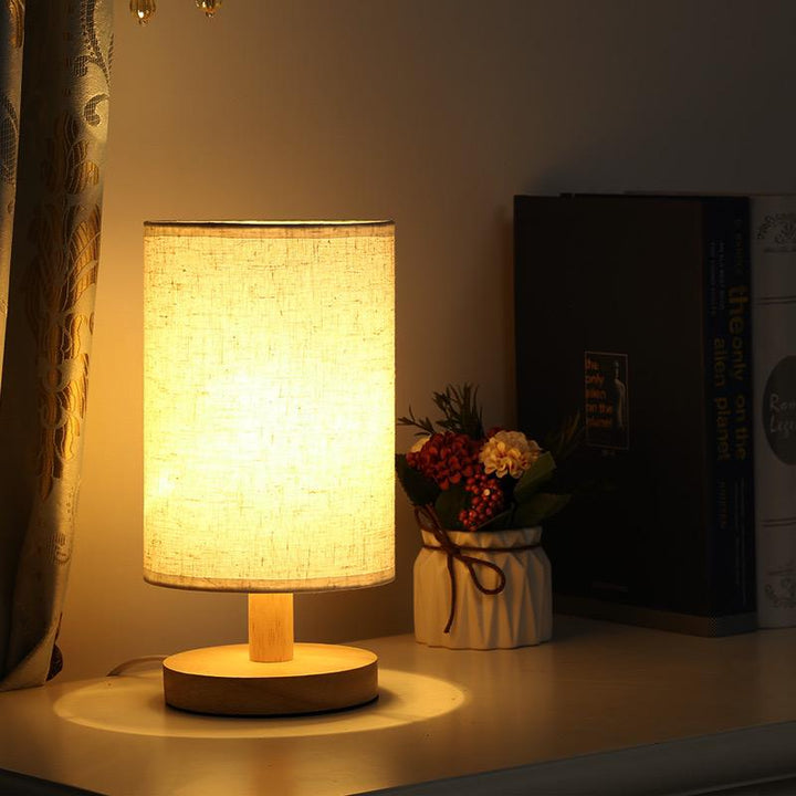 Ambient Dimmable Table Lamp with a unique organic glow, warm LED light, and sturdy wood base. Home essential.