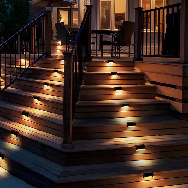Nvroome LED solar step lights illuminating a dark staircase, highlighting safety and landscape decor.