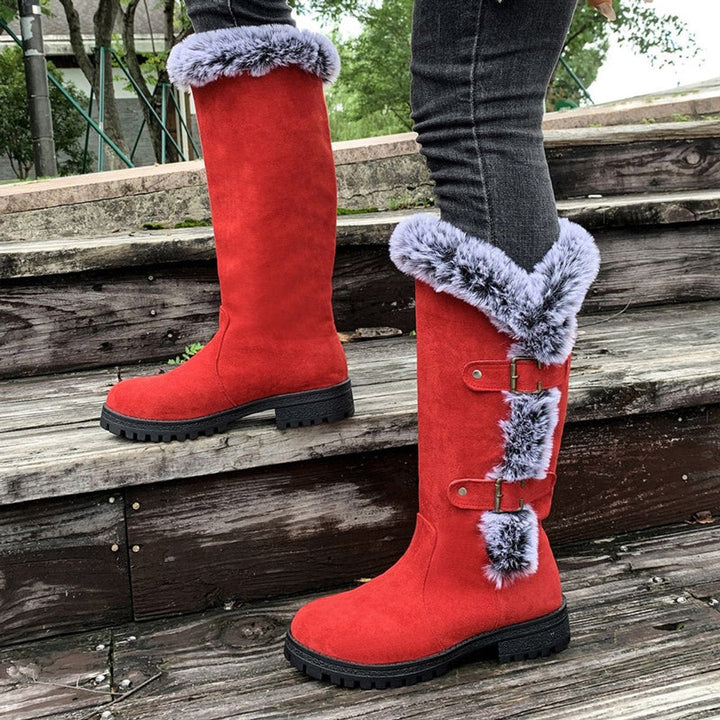 Black women's buckle knee-high boots. Cozy & stylish winter footwear, perfect for casual or fashion looks.