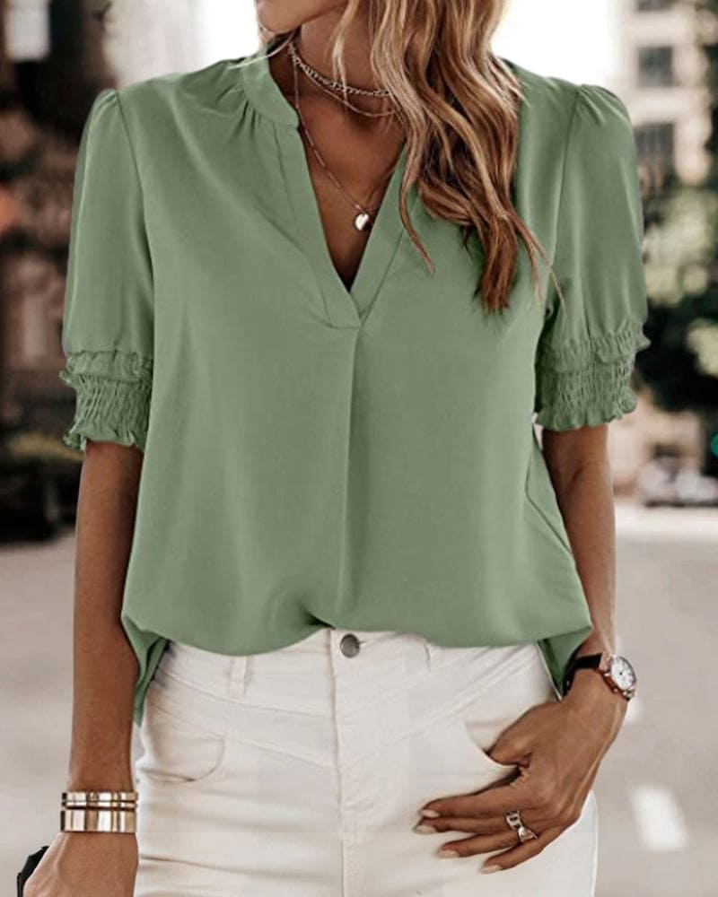 Women's V-neck short sleeve puff blouse. Chic, comfortable top for spring/summer casual wear.