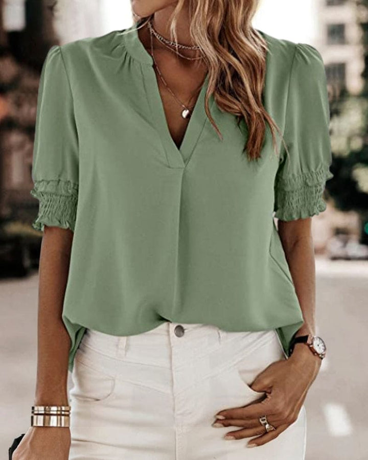 Women's V-neck short sleeve puff blouse. Chic, comfortable top for spring/summer casual wear.