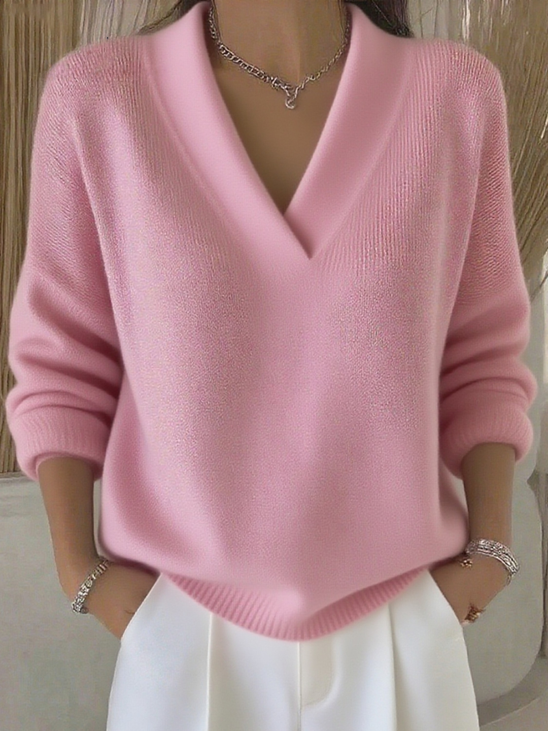 Fashionable women's V-neck long-sleeve sweater, offering cozy comfort and elegant style for any occasion.