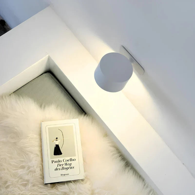 Magnetic LED wall lamp, dimmable & rechargeable, provides accent lighting for any space.