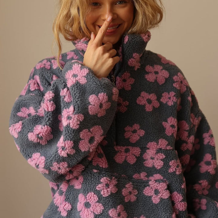 Women's cozy half-zip oversized sweater featuring a stylish floral print and soft teddy fleece.
