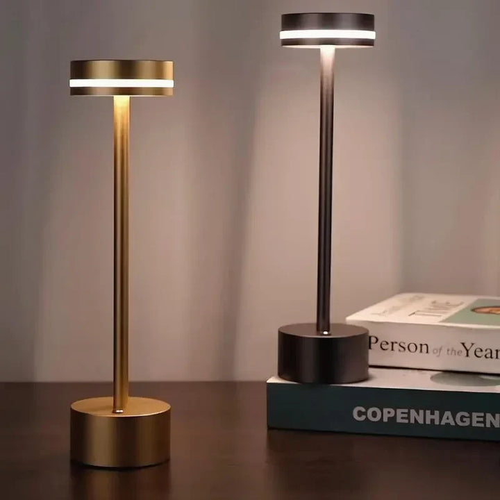 Cordless LED table lamp, rechargeable and touch-controlled, casting warm, customizable ambient light.