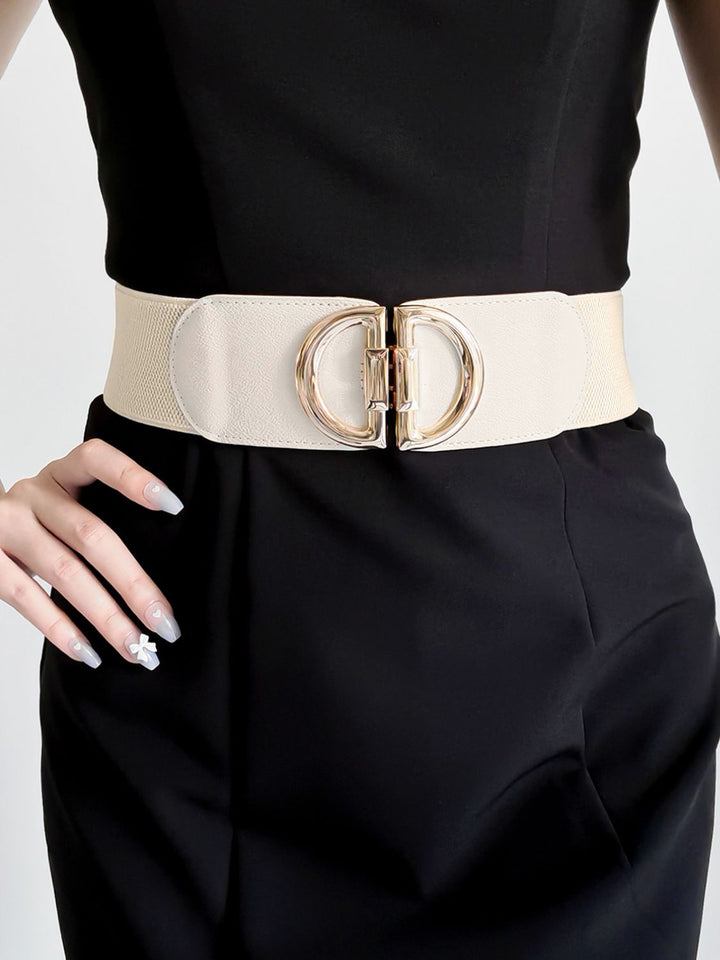 Gold buckle detail on a women's wide elastic waist belt, ideal for cinching and styling.