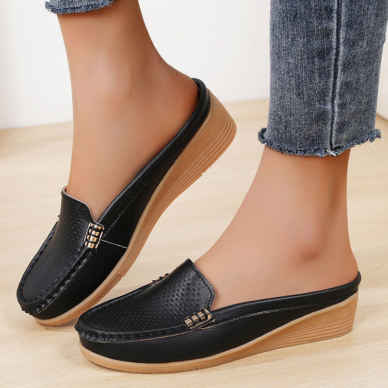 Versatile women's flat mules, a comfortable slip-on sandal with a subtle wedge heel.