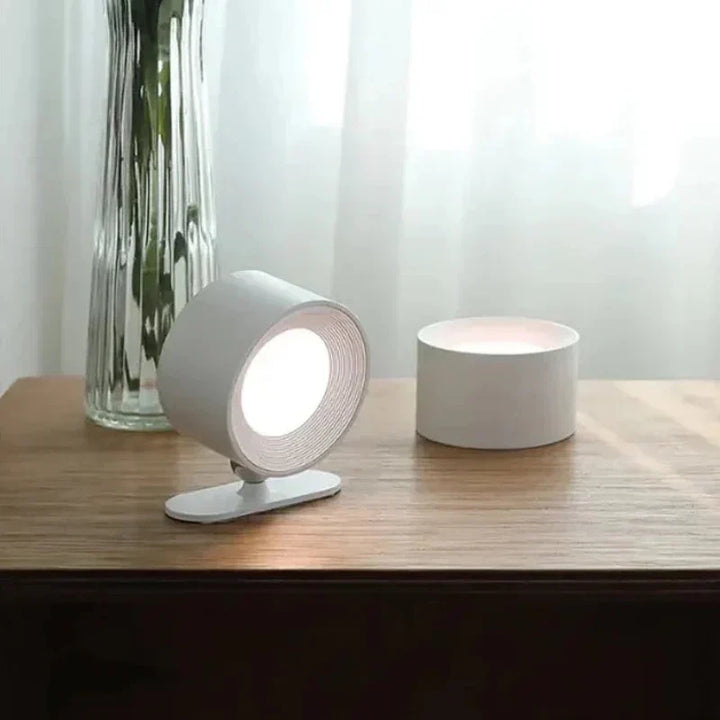 Adjustable cordless LED wall lamp, 360° rotating head for versatile home decor lighting.