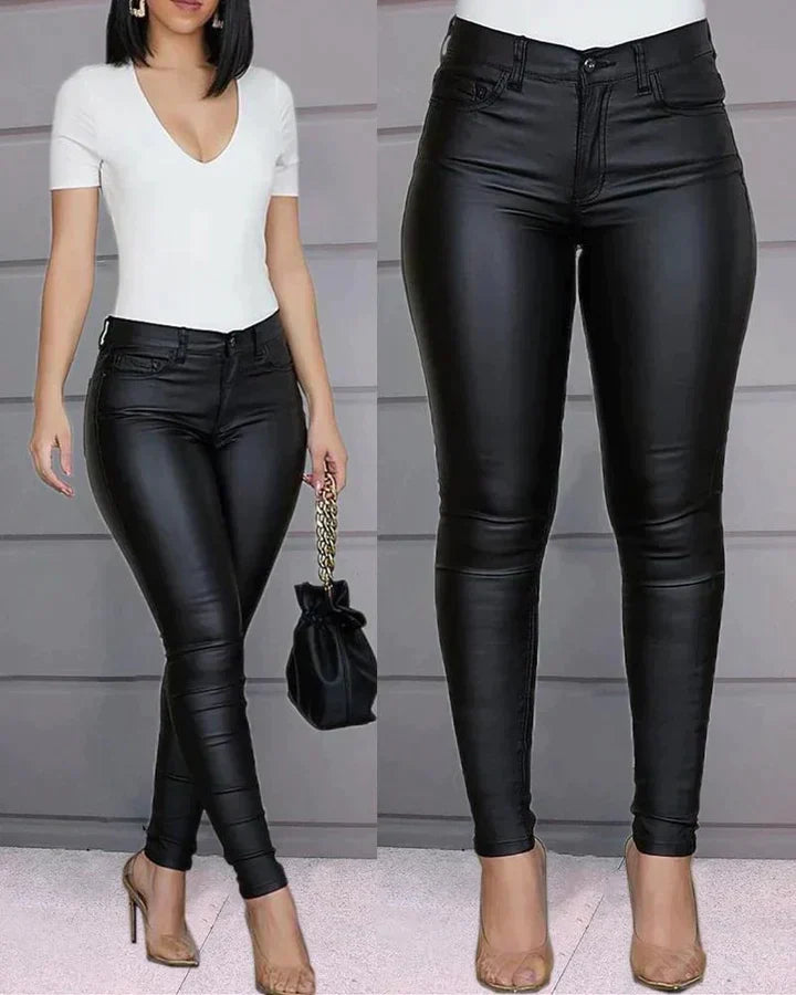 Women's black faux leather stretch pants, offering a sleek look & comfortable fit for modern style.