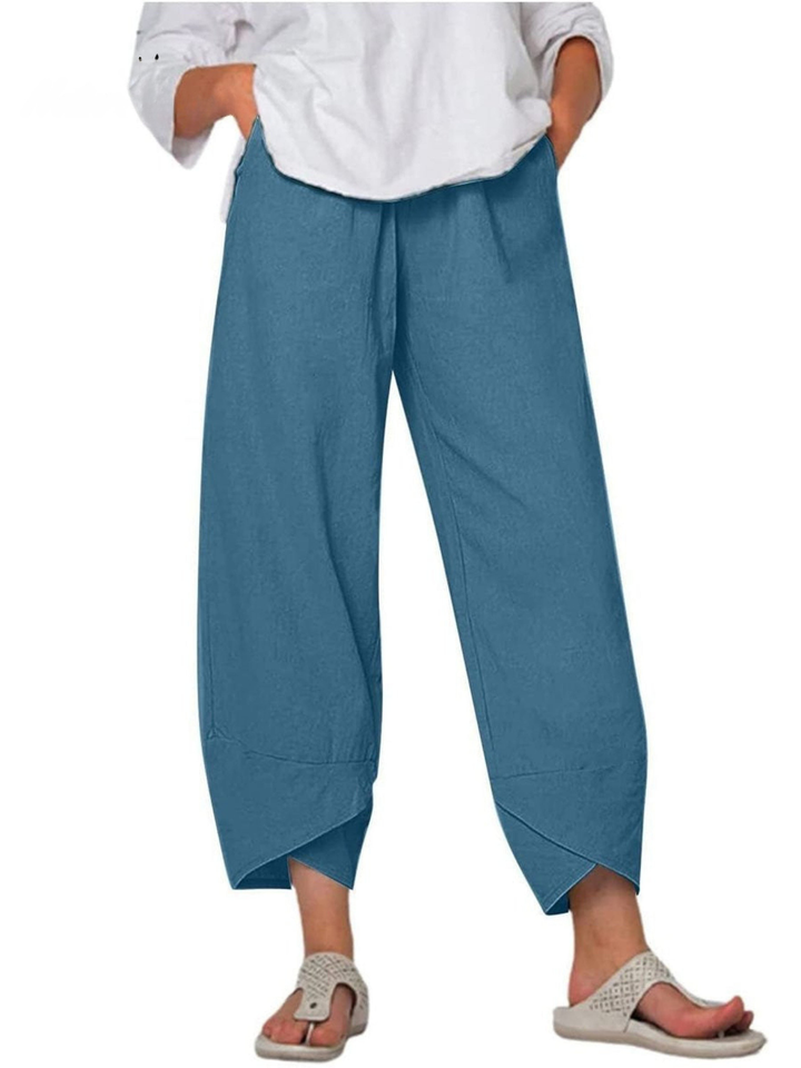 Front view of woman wearing comfortable linen wide leg harem pants, casual loose fit trousers.