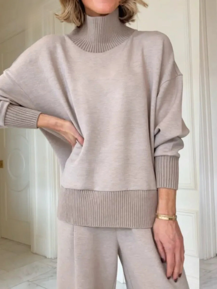 Cozy women's knit two-piece loungewear set, featuring a soft jumper and comfortable wide-leg trousers for ultimate relaxation.