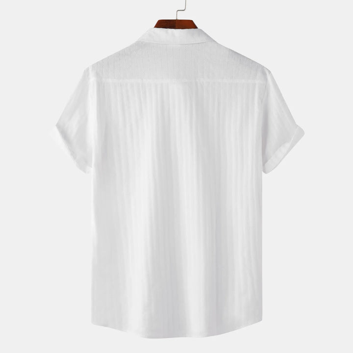 Classic fit men's short sleeve button-down shirt, offering smart casual style and everyday comfort. Chest pocket.