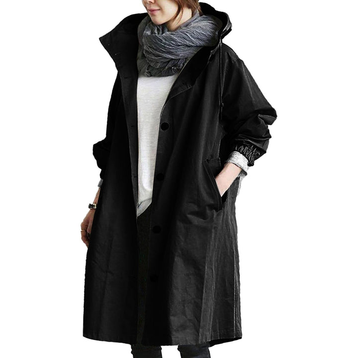 Woman modeling a chic long waterproof raincoat, ideal for urban rainwear and elegant outerwear.