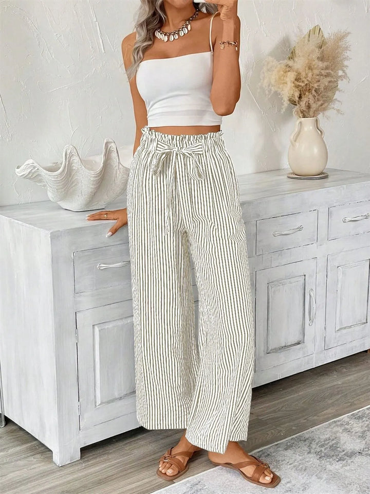 Stylish striped wide leg women's pants, featuring a paperbag waist and pockets.