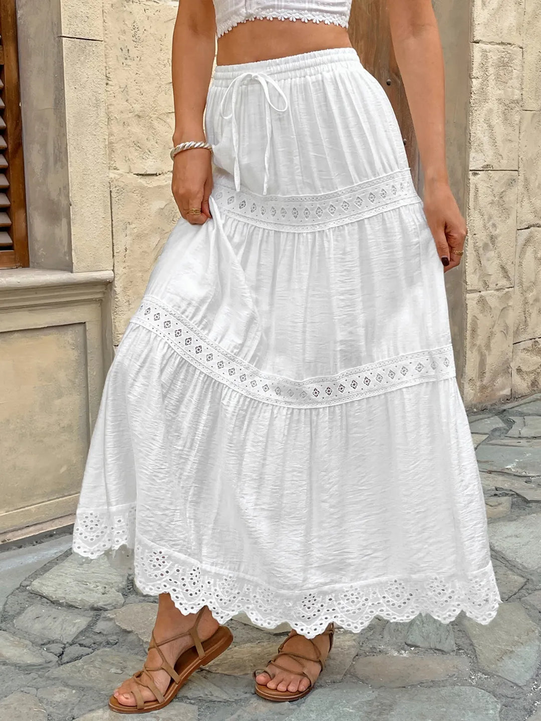 Elegant white lace tiered maxi skirt for women, ideal for beach outings or stylish summer fashion.