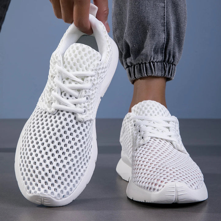 Modern women's casual white sneakers worn for everyday comfort, ideal for travel and walking.