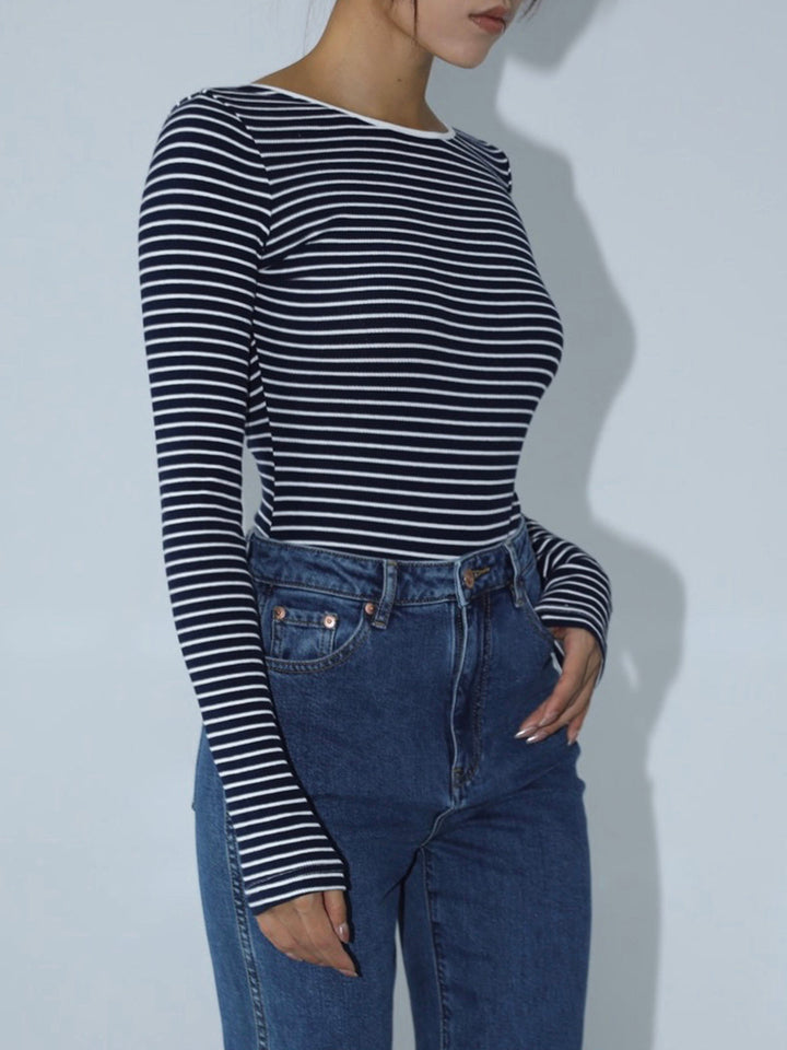 Form-fitting women's striped long sleeve open-back bodysuit, perfect for casual or evening wear. Elegant top.
