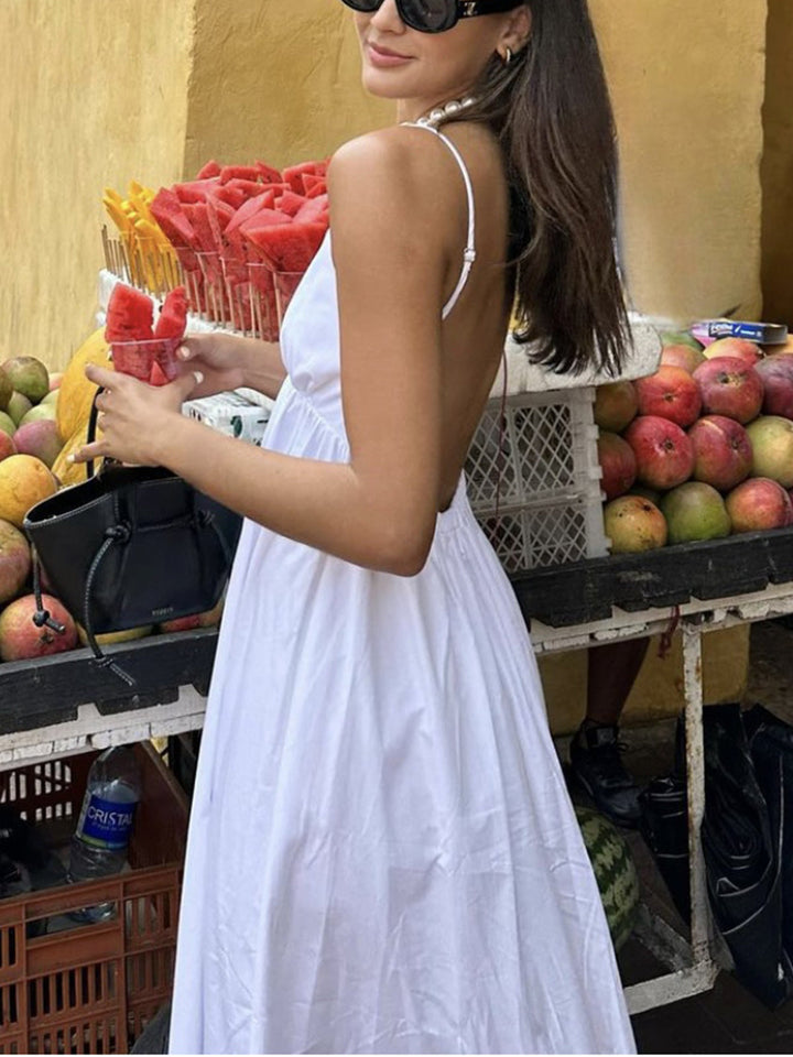 Perfect holiday midi dress: women's open-back V-neck, sleeveless, elegant for summer events.