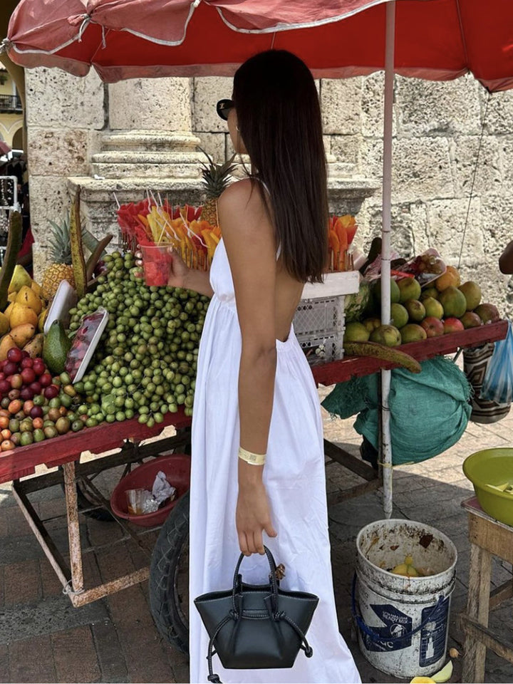 Sleeveless women's V-neck midi dress, featuring a stylish open back, ideal for elegant summer fashion.