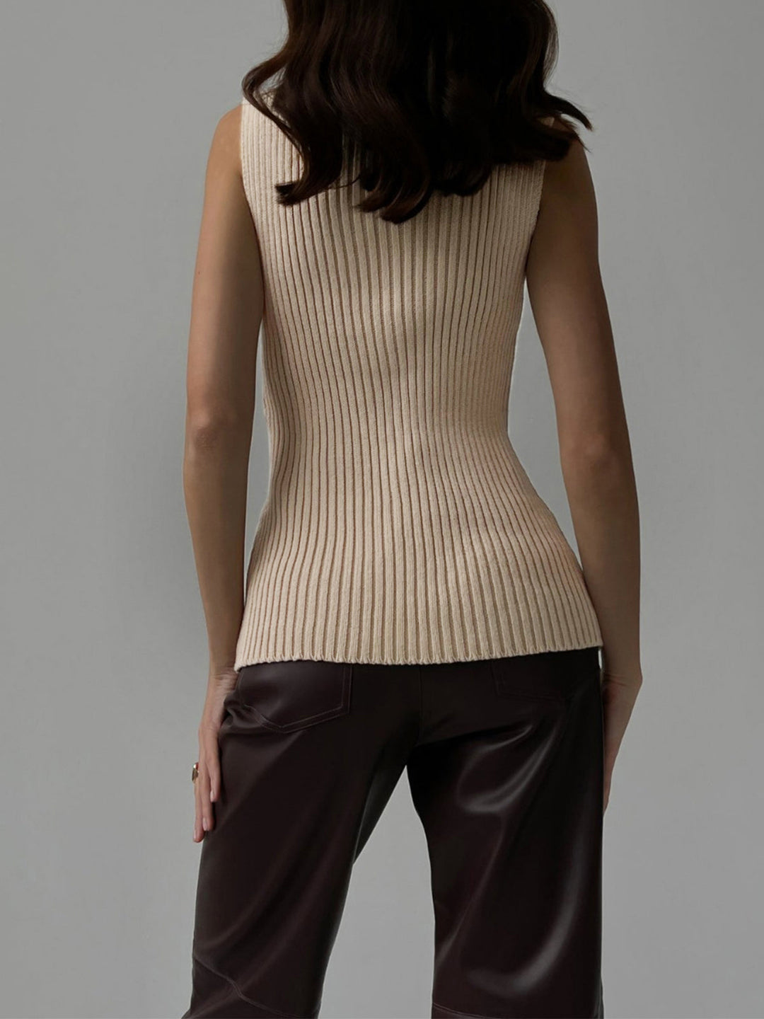 Chic women's ribbed mock neck sleeveless top, perfect for layering or casual wear.