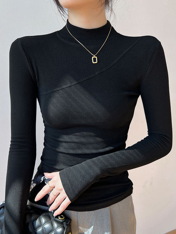 Close-up of a women's mock neck long sleeve top. Fitted silhouette offers a chic, modern look for any outfit.