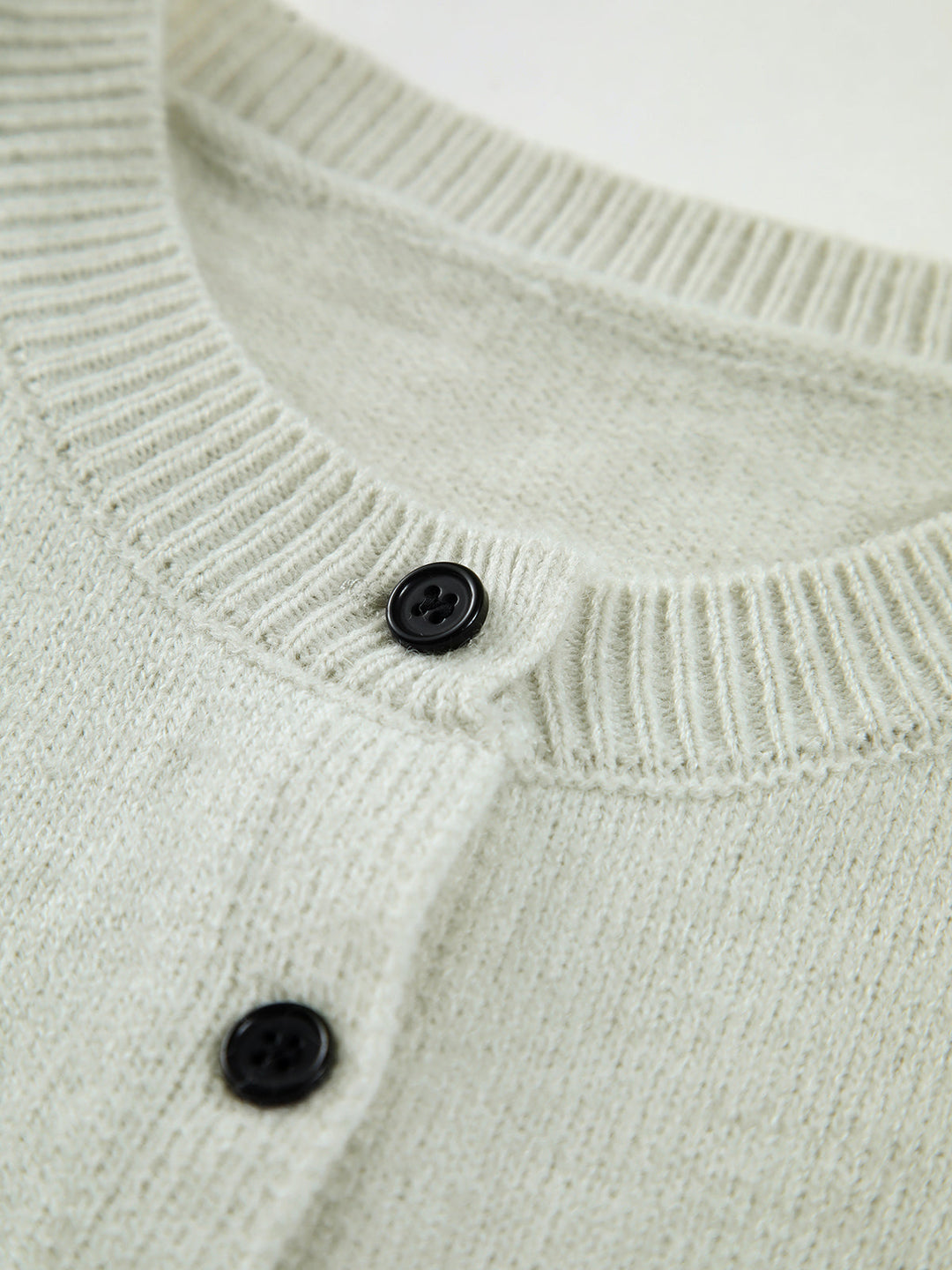 Effortless women's button-up sweater vest, a chic layering piece perfect for modern transitional apparel.