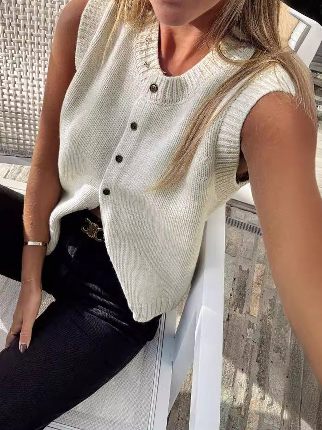 Light grey women's button-up sweater vest, a chic sleeveless top for modern layering and transitional outfits.