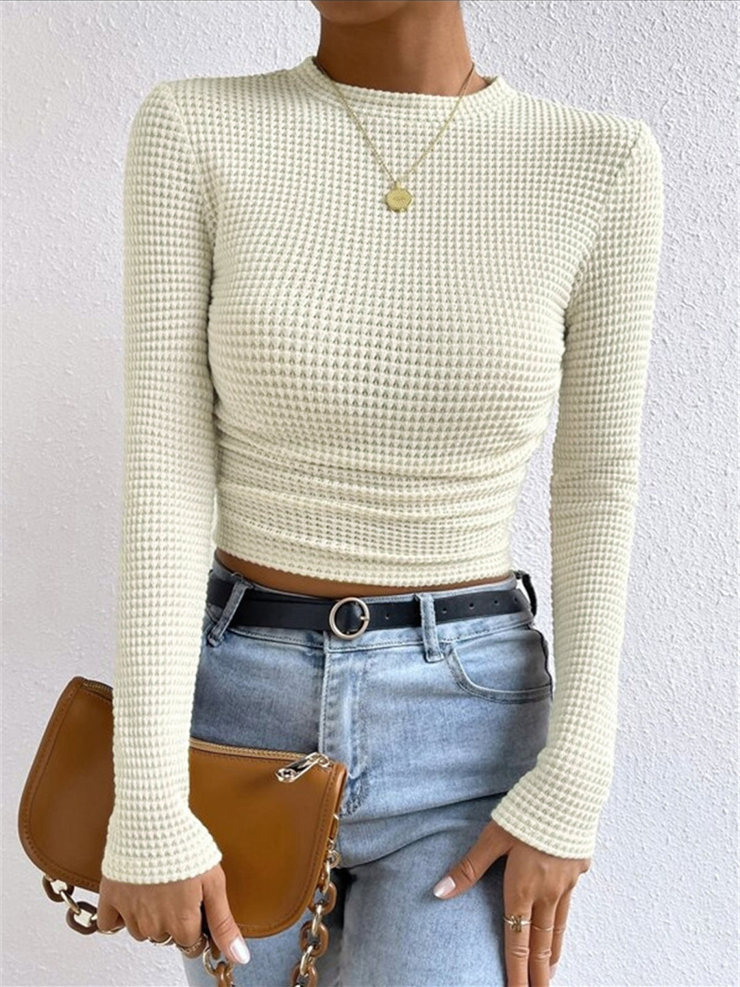 Stylish women's cropped waffle knit long sleeve top, ideal for layering and effortless winter comfort.