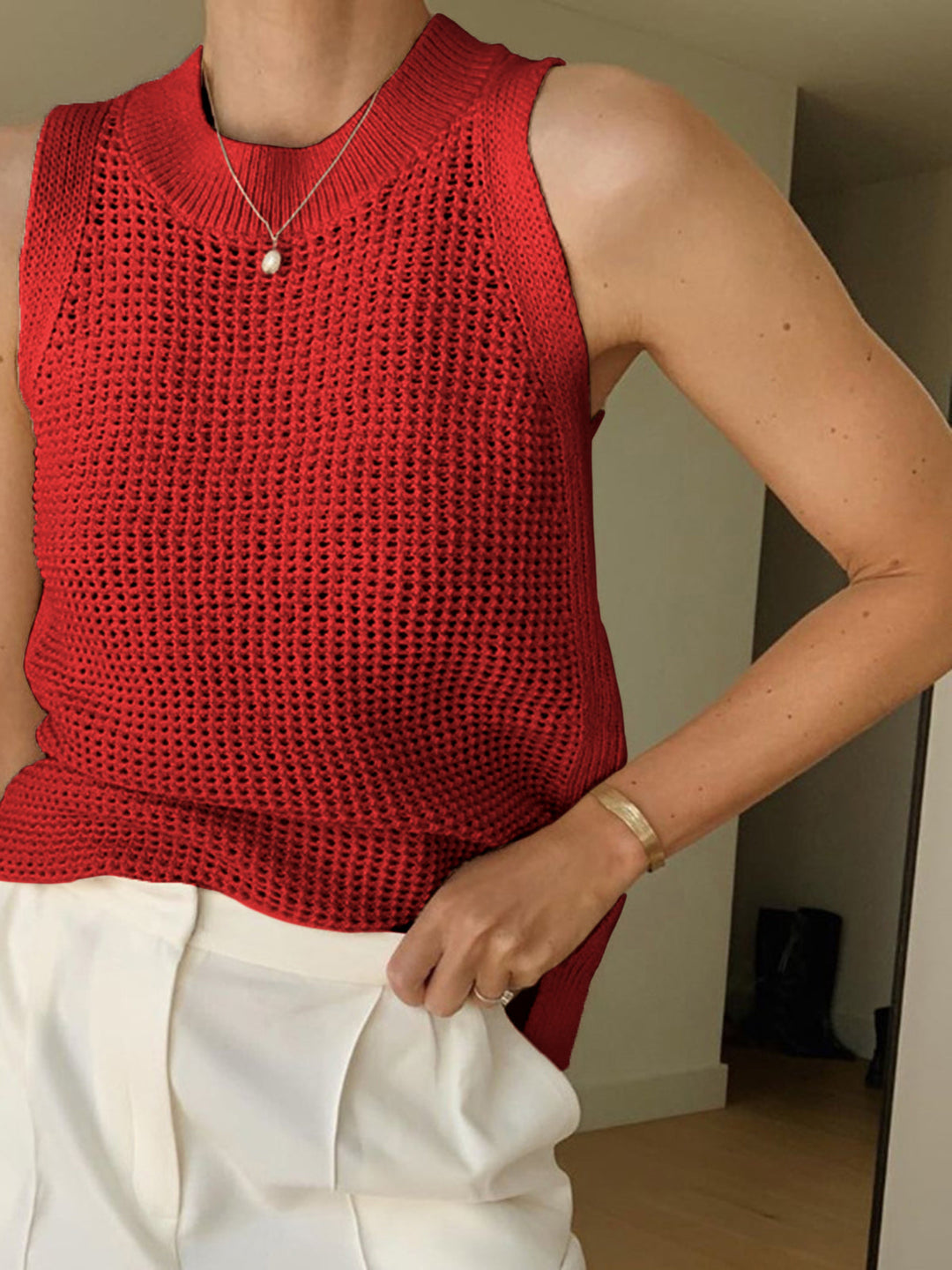 Stylish women's sleeveless hollow knit top, ideal for breezy summer days & comfortable casual wear. One size.