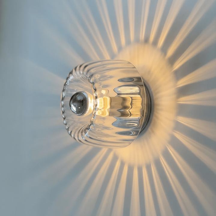 Decorative Bauhaus LED wall sconce, a modern metal & glass lamp, enhances stylish home decor indoors.
