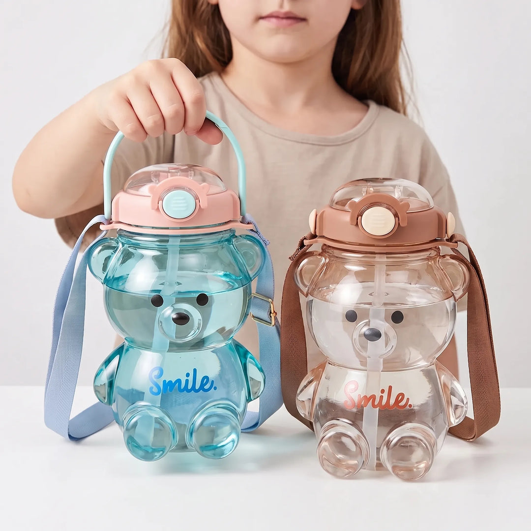 Cute bear-shaped water bottle for kids, includes a practical shoulder strap for easy carrying to school.