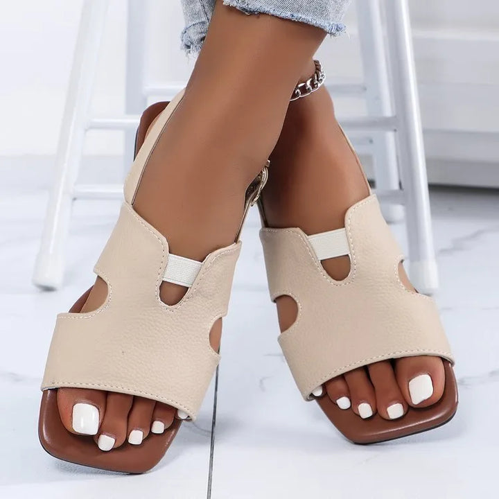 Women's stylish cut-out flat sandals, perfect for casual summer wear. Chic slip-on design with an open toe.